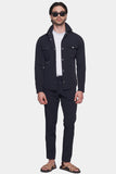 Man wearing a dark jacket and pants on a white background