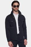 Man wearing a black jacket over a white shirt on a white background