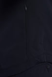 Close-up of a black jacket with a zipper and button details.