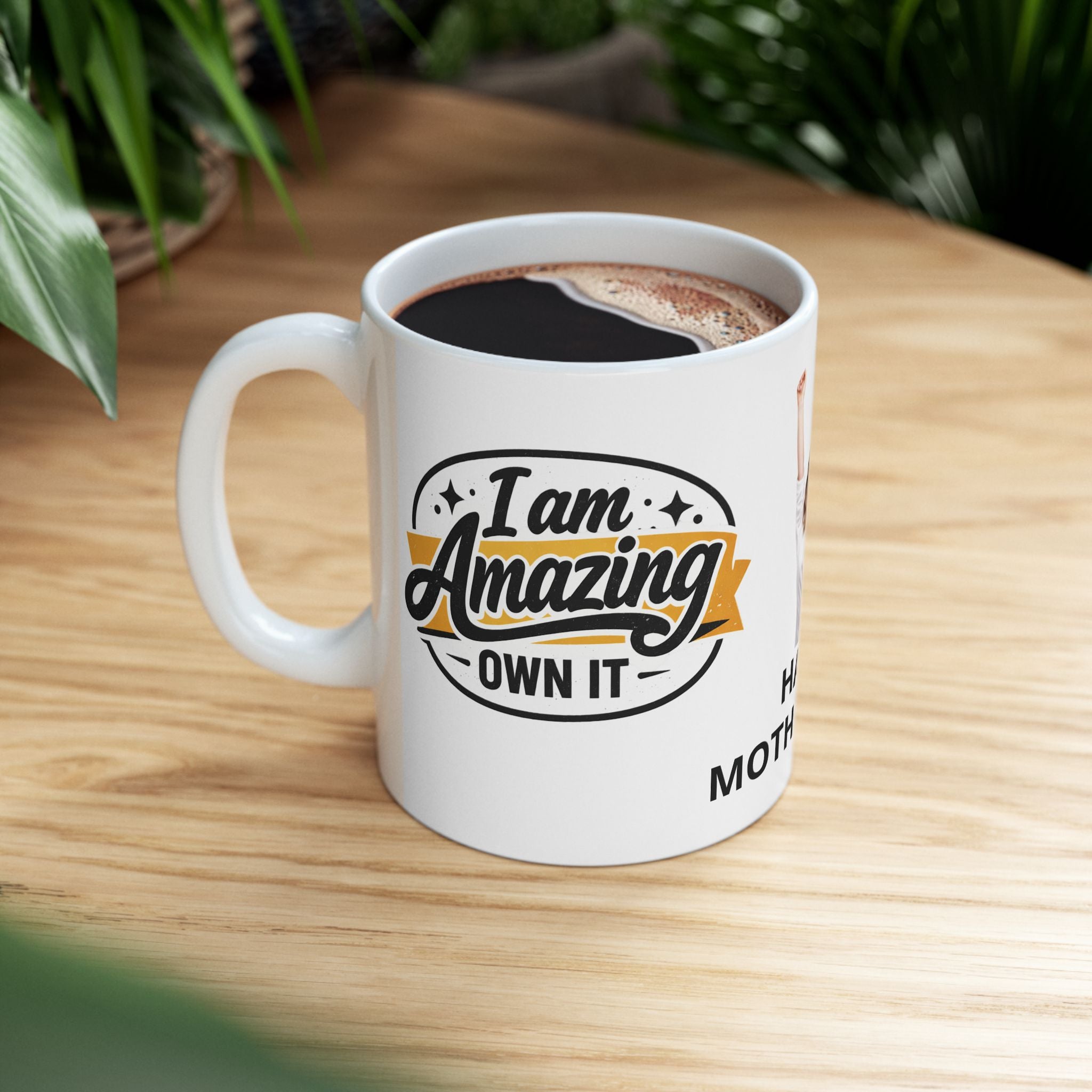 Mug with 'I am Amazing, Own It' text on a wooden table