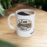 Mug with 'I am Amazing, Own It' text on a wooden table