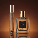 Two perfume bottles with gold caps on a brown background