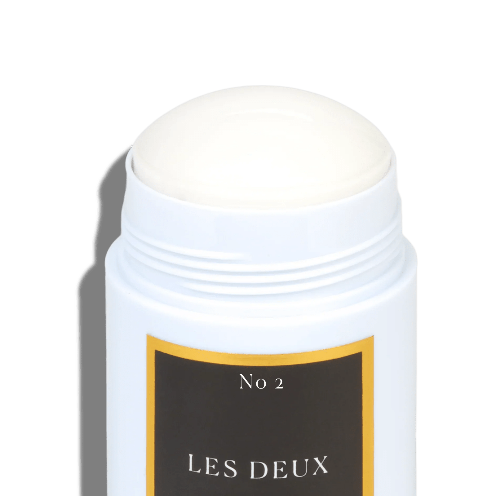 White deodorant stick with a black label on a green background