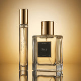 Two perfume bottles labeled 'No 2' on a reflective gold surface with a gradient background.