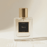 Perfume bottle labeled 'No 2' by 'Les Deux' on a beige background