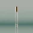 Clear perfume bottle with gold cap on a gradient green background