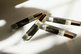 Five small glass bottles with metallic caps labeled 'No. 1' to 'No. 5' on a light background.