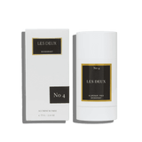 Deodorant stick and packaging with 'Les Deux' branding on a green background