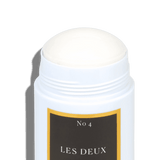 White deodorant stick with a black and gold label on a gray background