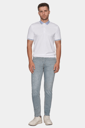 Man wearing a white polo shirt and light gray pants on a white background