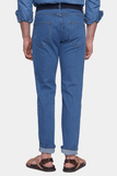 Person wearing blue jeans on a white background
