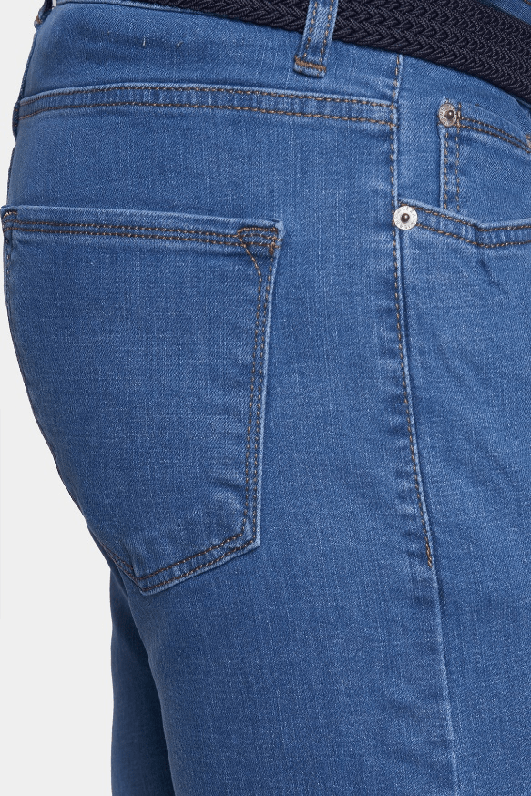 Close-up of blue jeans with a focus on the pocket and stitching.