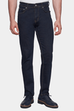 Dark blue jeans worn by a person on a white background