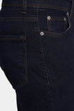 Close-up of dark blue jeans with stitching details on a white background