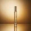 Perfume bottle with gold cap on a reflective surface and gold background